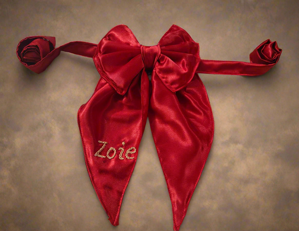Red satin bow with 'Zoie' embroidery, branded 'Zoie Boutique'.
