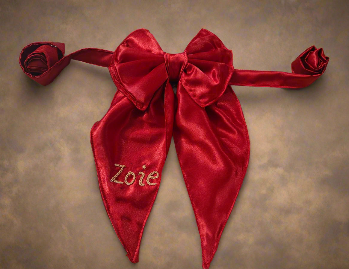 Red satin bow with 'Zoie' embroidery, branded 'Zoie Boutique'.